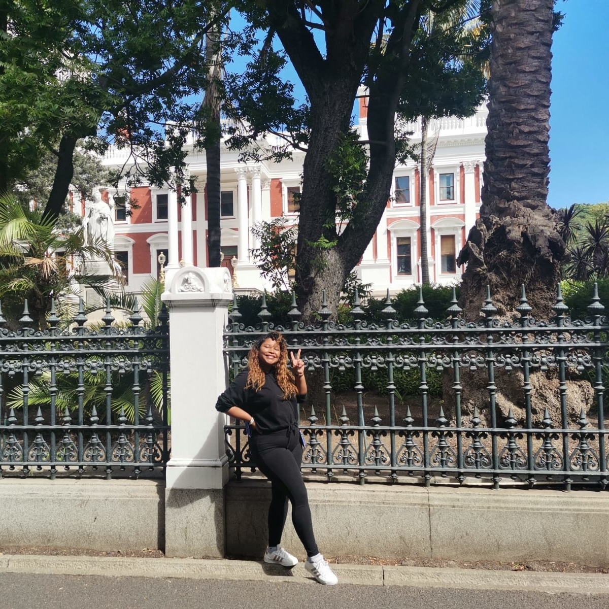 female standing on the side of Parliament of South Africa